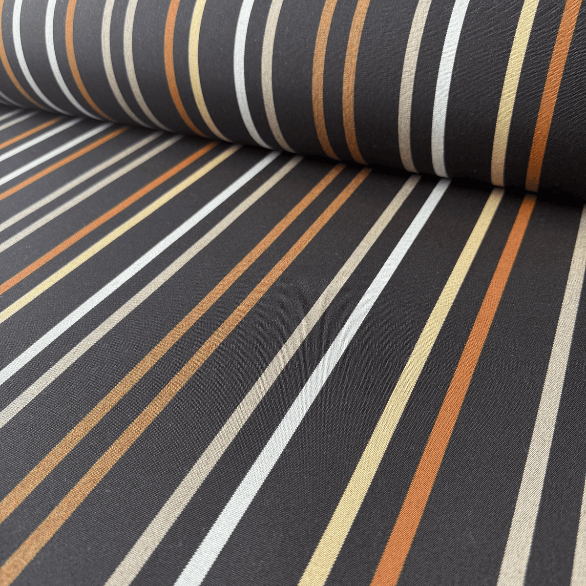 The sophisticated brown stripe design blends effortlessly into a wide range of outdoor settings, making Sunbrella Ginza Java 4775 canvas an ideal choice for both contemporary and traditional projects.